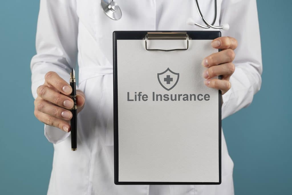 Doctor holding life insurance form