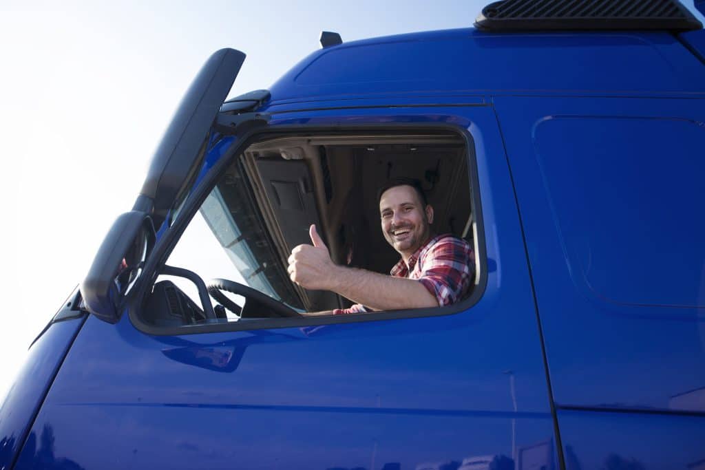 Truck driver showing thumbs up