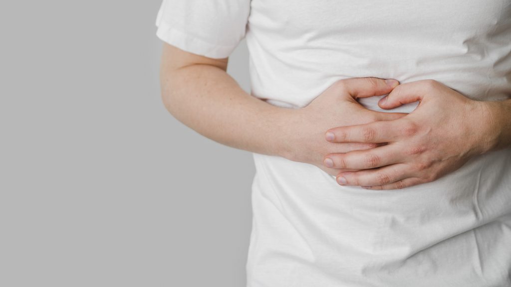 man with crohn's disease experiencing stomach ache